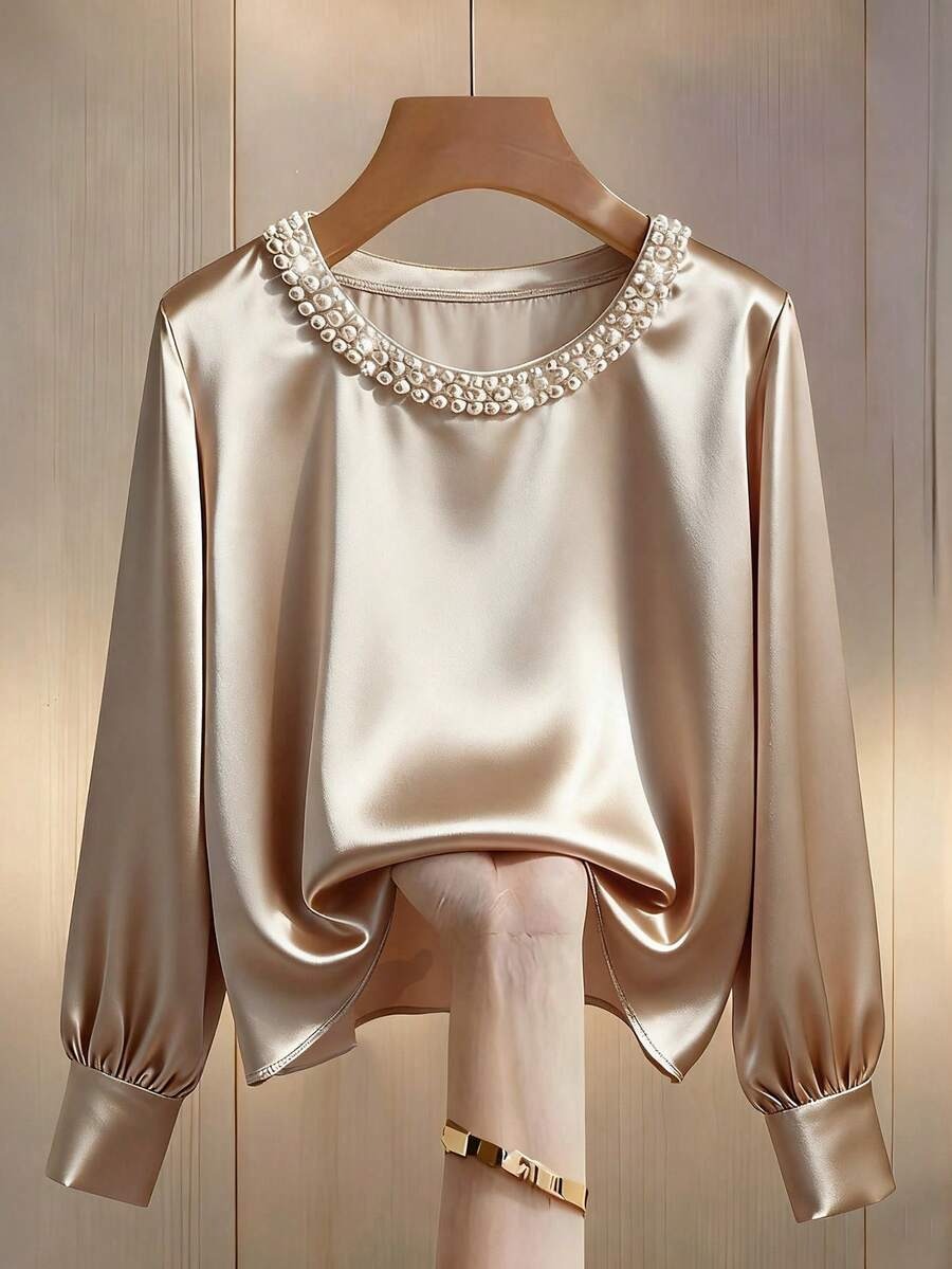Blusa con decoración de perlas en el cuello
