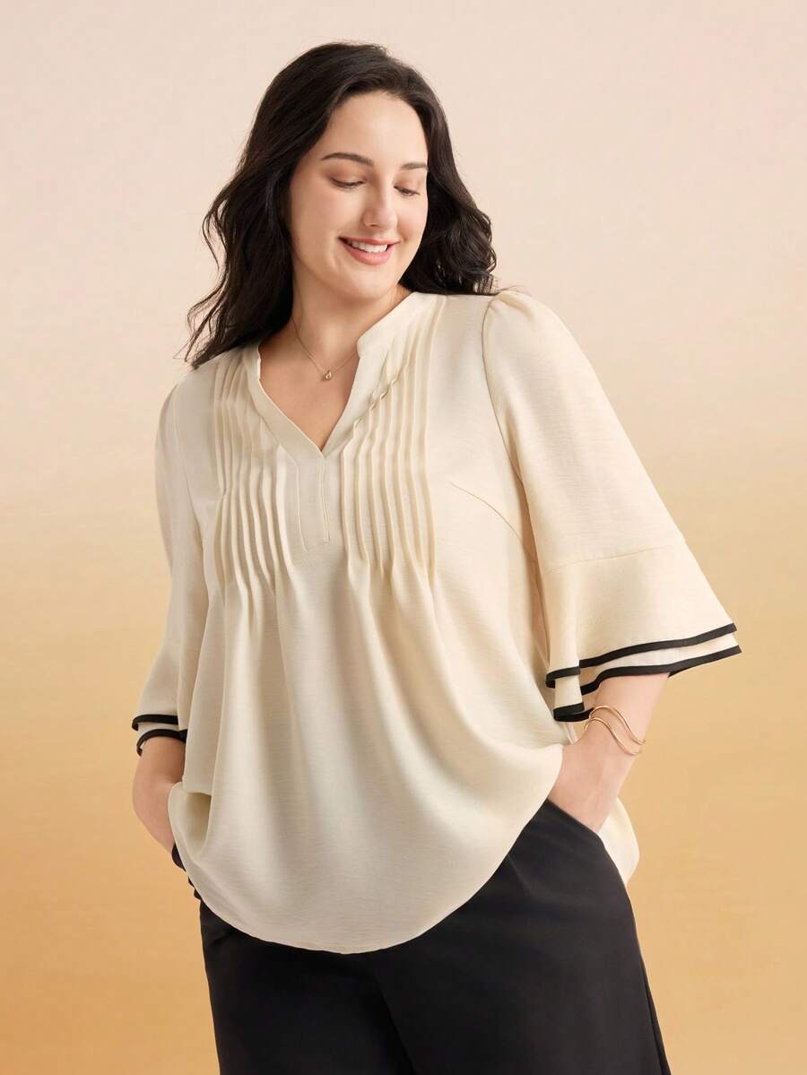 Blusa con pliegues frontales y magas con ribete