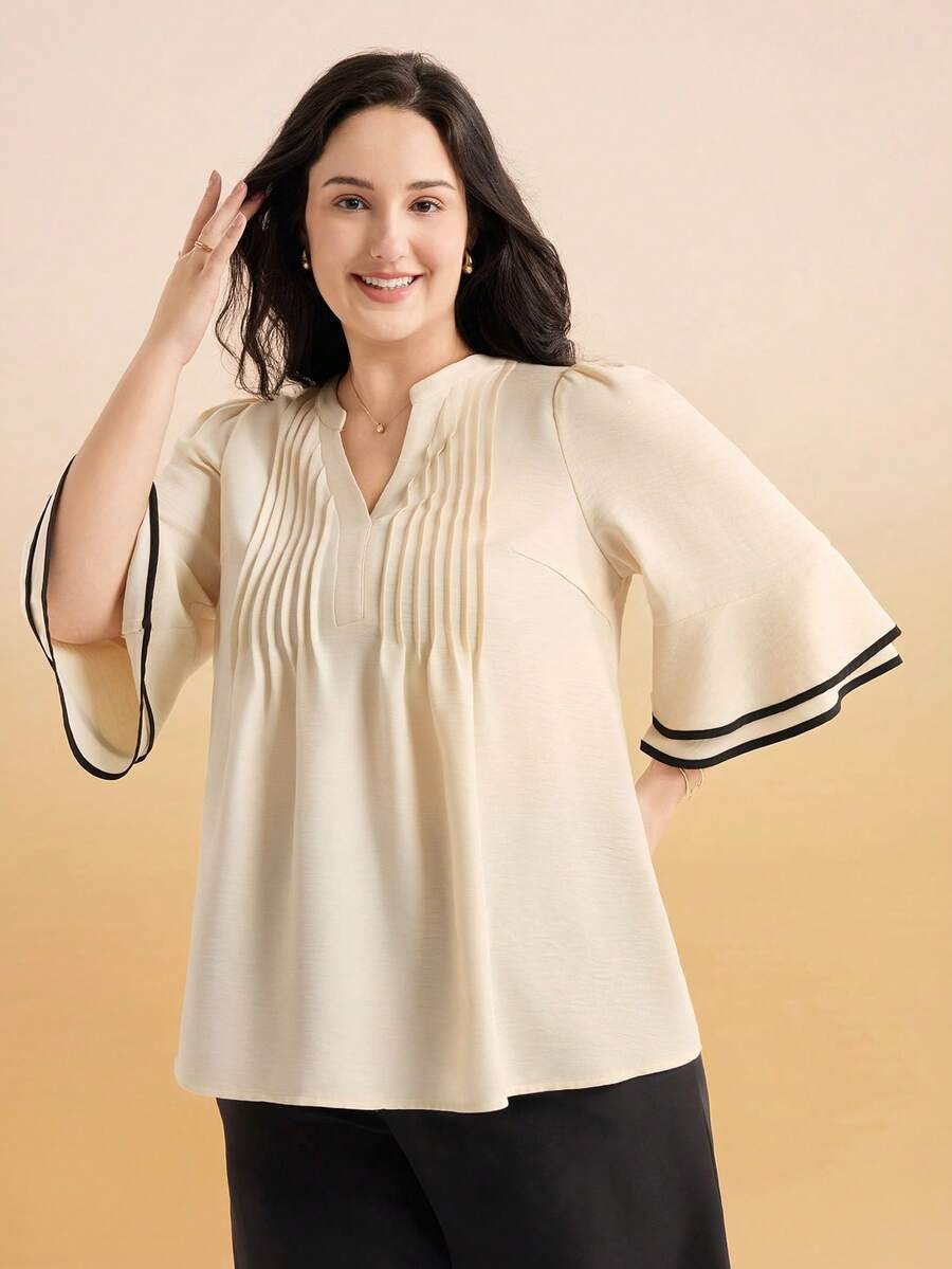 Blusa con pliegues frontales y magas con ribete