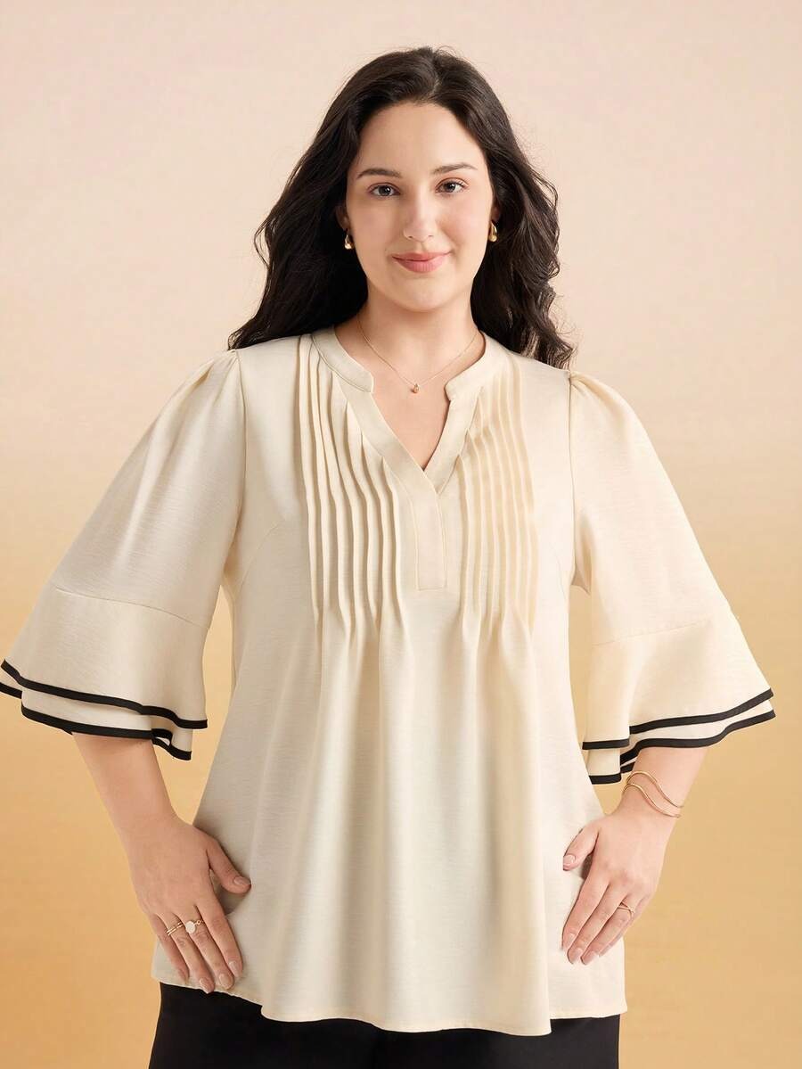 Blusa con pliegues frontales y magas con ribete