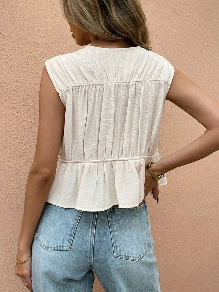 Blusa sin mangas con pliegues frontales y lazos