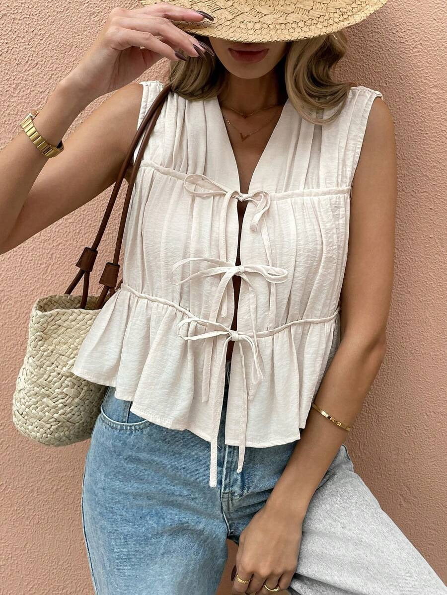 Blusa sin mangas con pliegues frontales y lazos